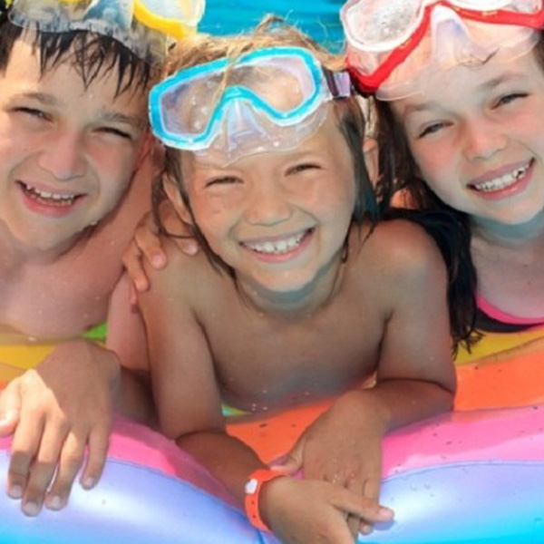kids at the pool smiling