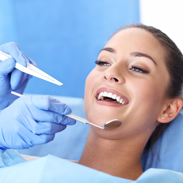 Picture of adult woman having a visit at the dentist's