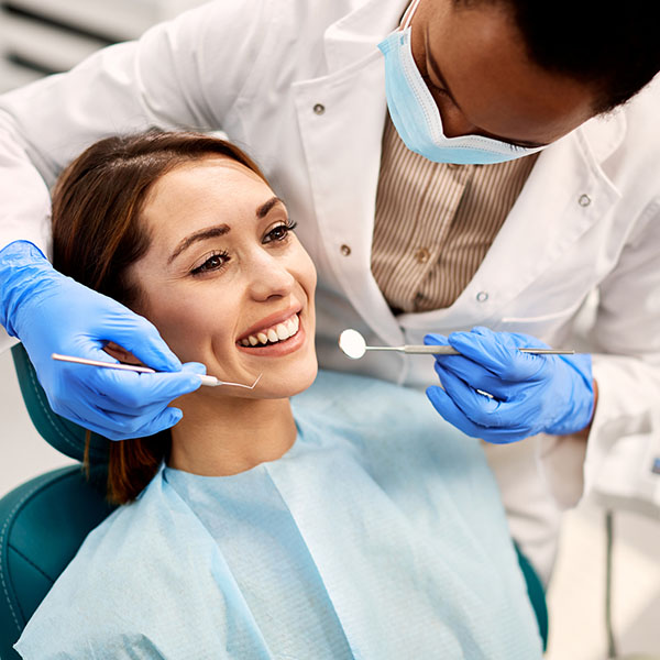 doctor checking patient's teeth